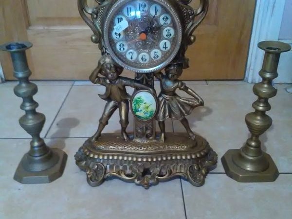 brass antique candle sticks with mantle clock