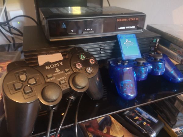 Playstation 2 + 2 controllers + 2 memory cards and lots of games