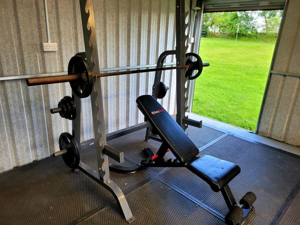 Squat Rack w/ Olympic Bar, Weighted plates & bench