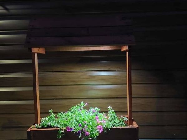 Wishing well planter with solar panels and light
