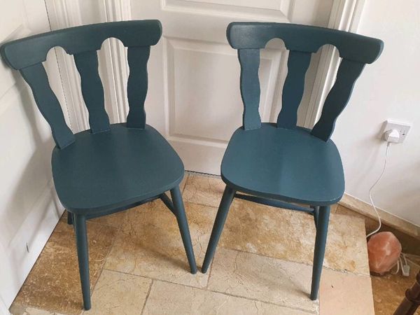 Two grey hardwood chairs
