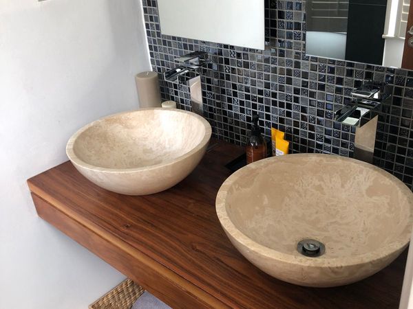 Walnut bathroom counter and stone basins