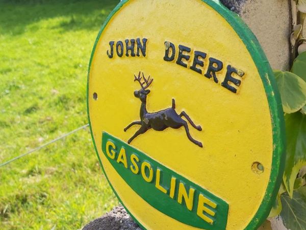 John Deere cast iron sign
