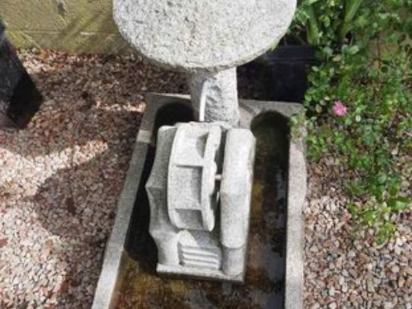 Carved stone fountain with spinning watermill