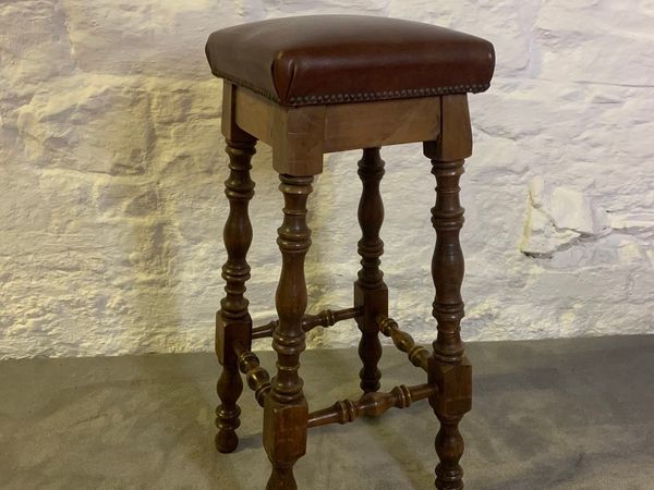 Vintage high stool with leather seat.
