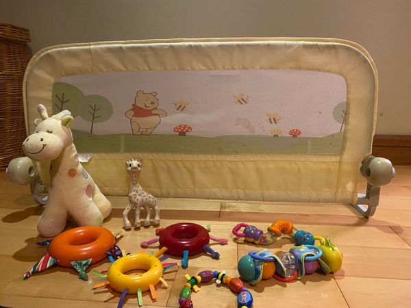 Bed guard rail, cuddly giraffe rattle and tethers