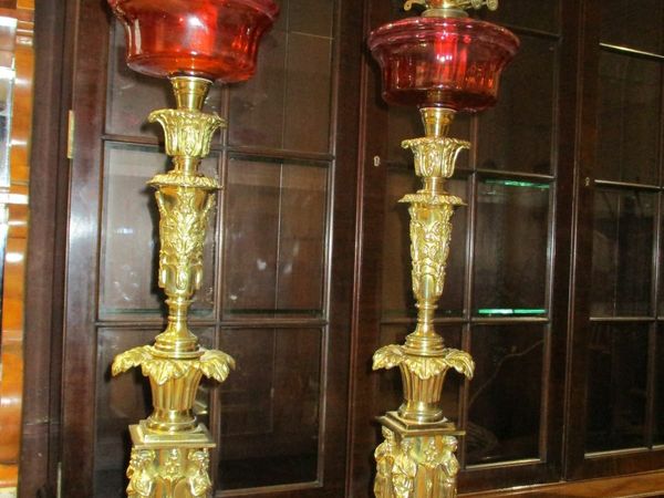 fine a pair of victorian ruby oil lamps