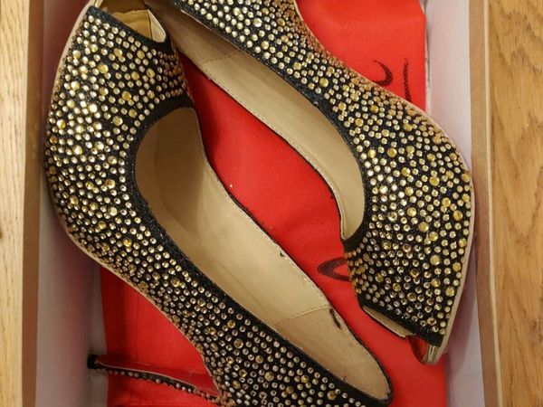 Gold and black Louboutin shoes