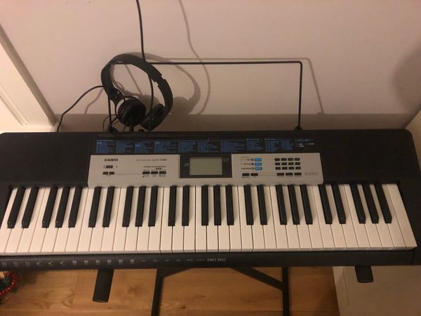 Casio keyboard with earphones and stand