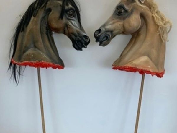 2 large life size theatrical horse heads.