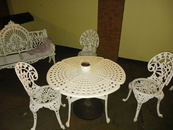 Very heavy cast iron table and 3  chairs