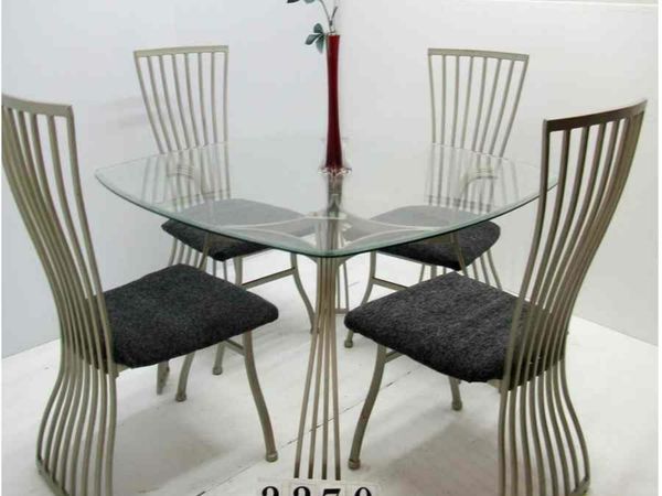 Glass and metal table and 4 chairs.   #2270
