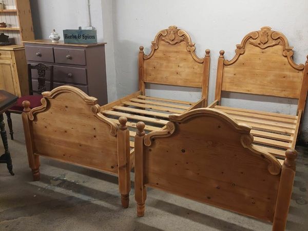 Pair of stripped pine carved single beds