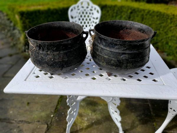 A pair of cast iron skillet pots