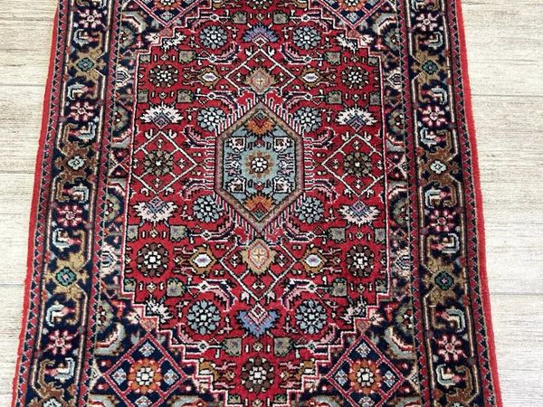 Original hand knotted P.ersian rug with label