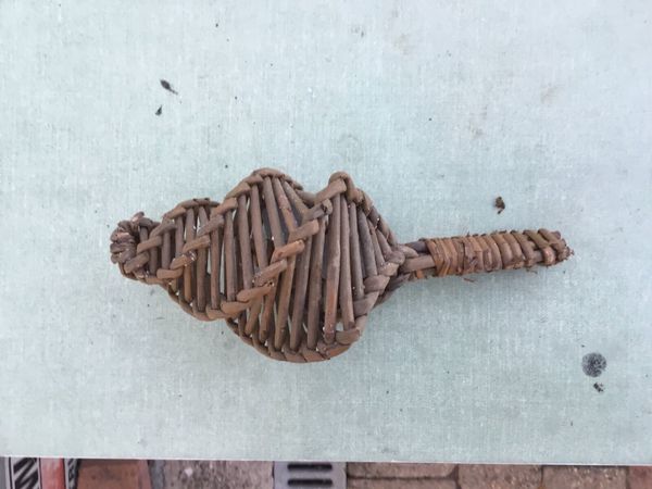 Baby rattle with wicker and stones.