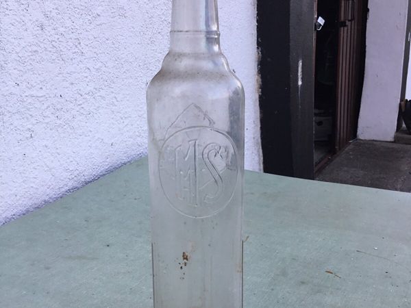 An very old motor oil bottle (MS) brand.