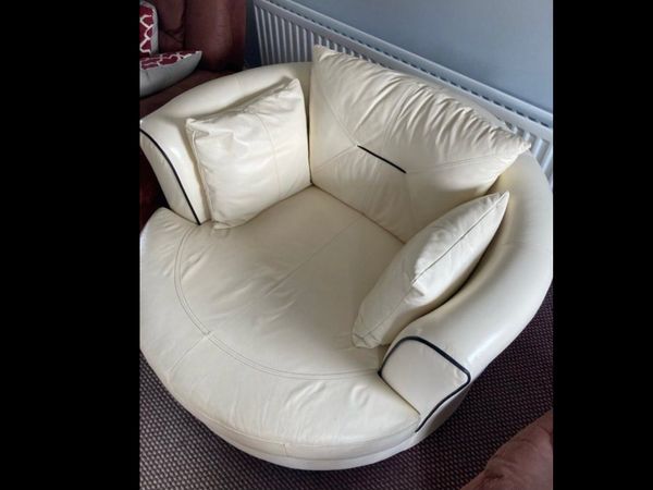 Swivel leather cream arm chair with footstool