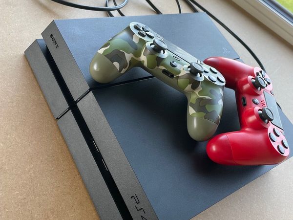 PlayStation 4 with two controllers