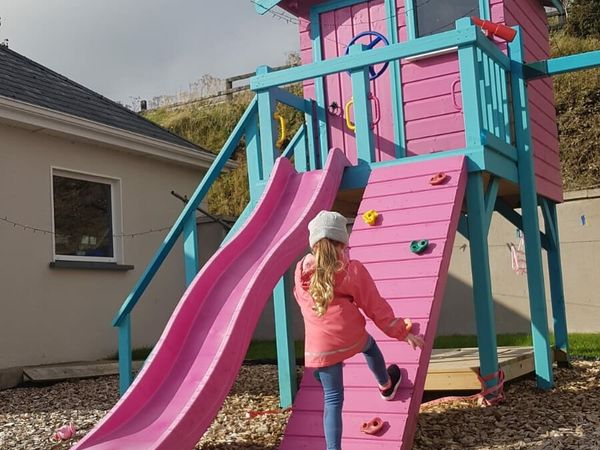 Childrens playhouse with swings,climbing wall,