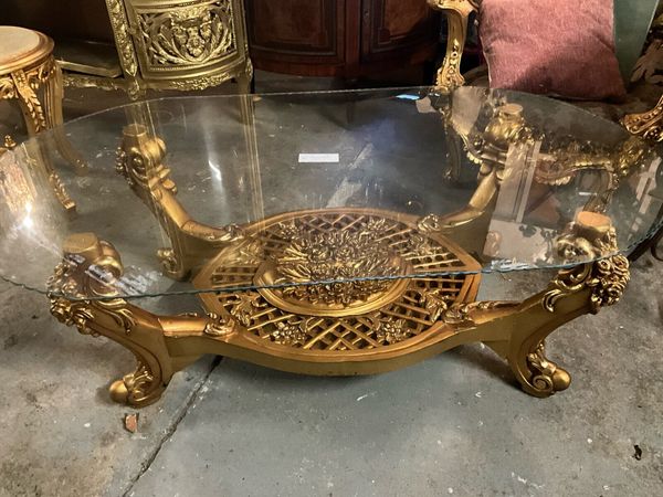 Oval glass and gold store coffee table