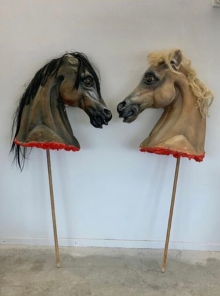 2 large life size theatrical horse heads.