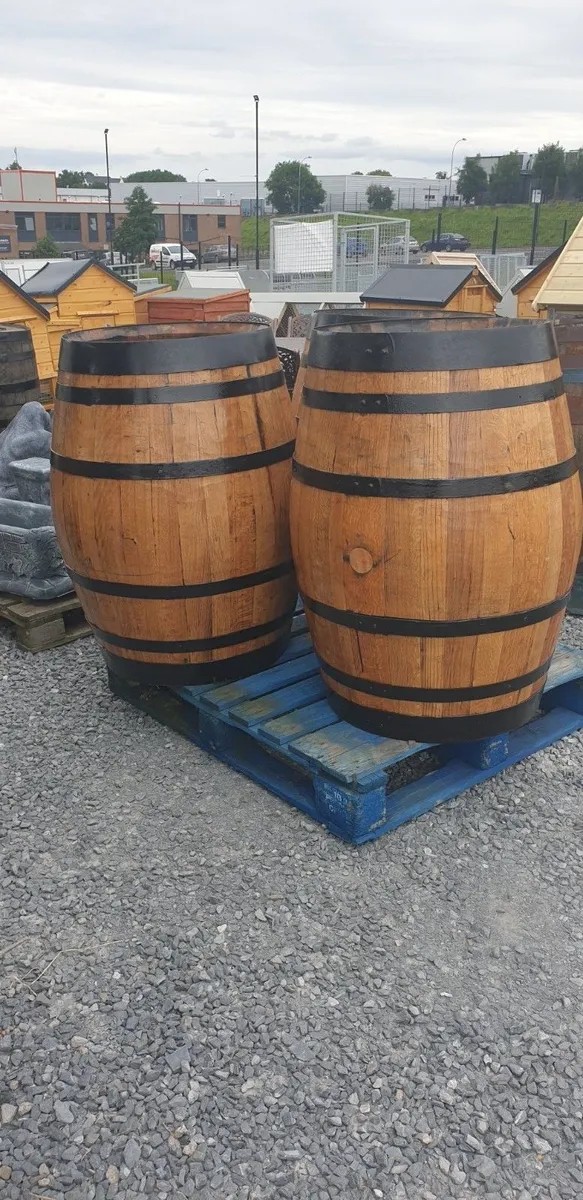 Full Oak barrels and half barrel planters painted - Image 1