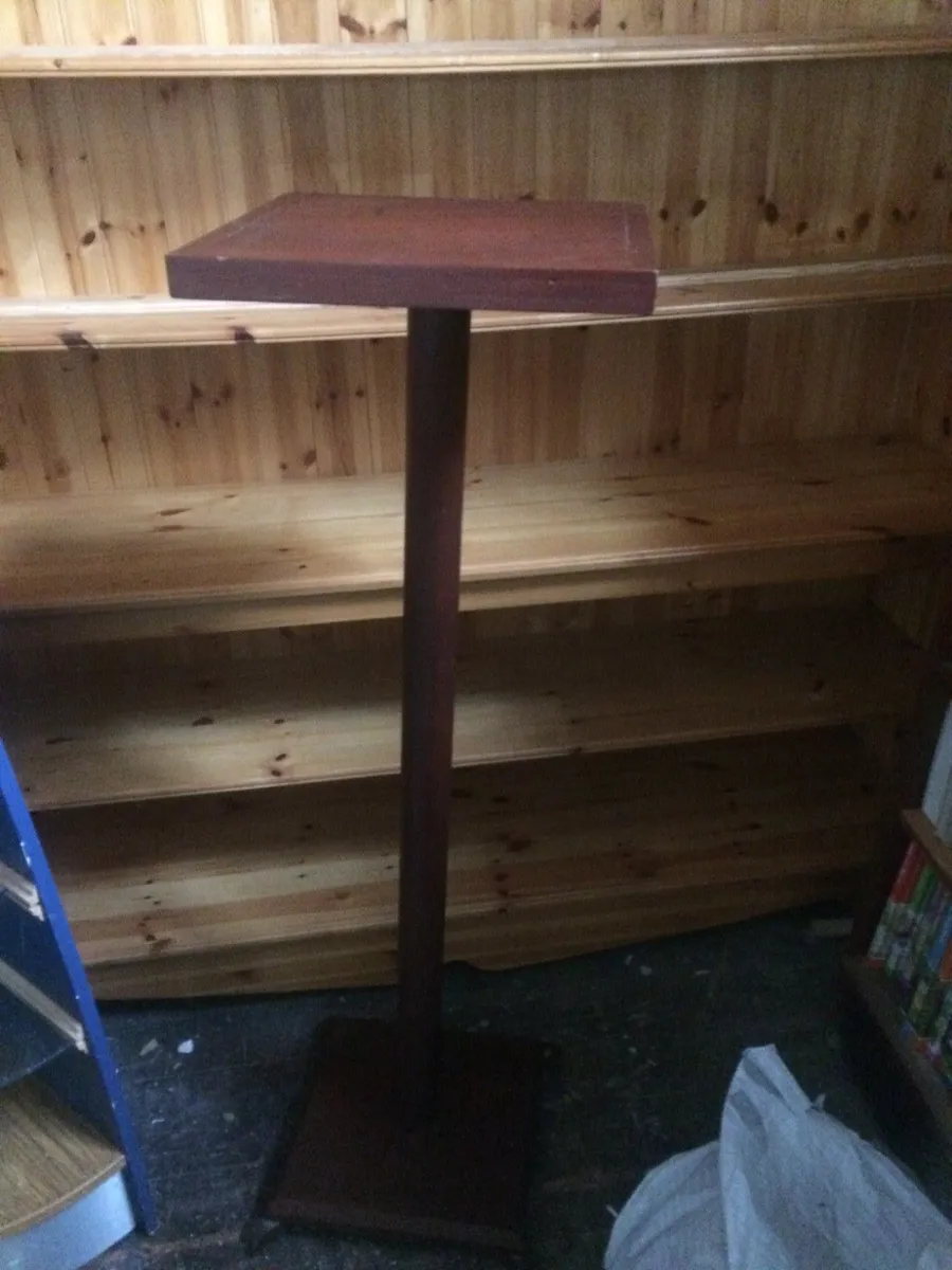tall wooden display stand on four legs