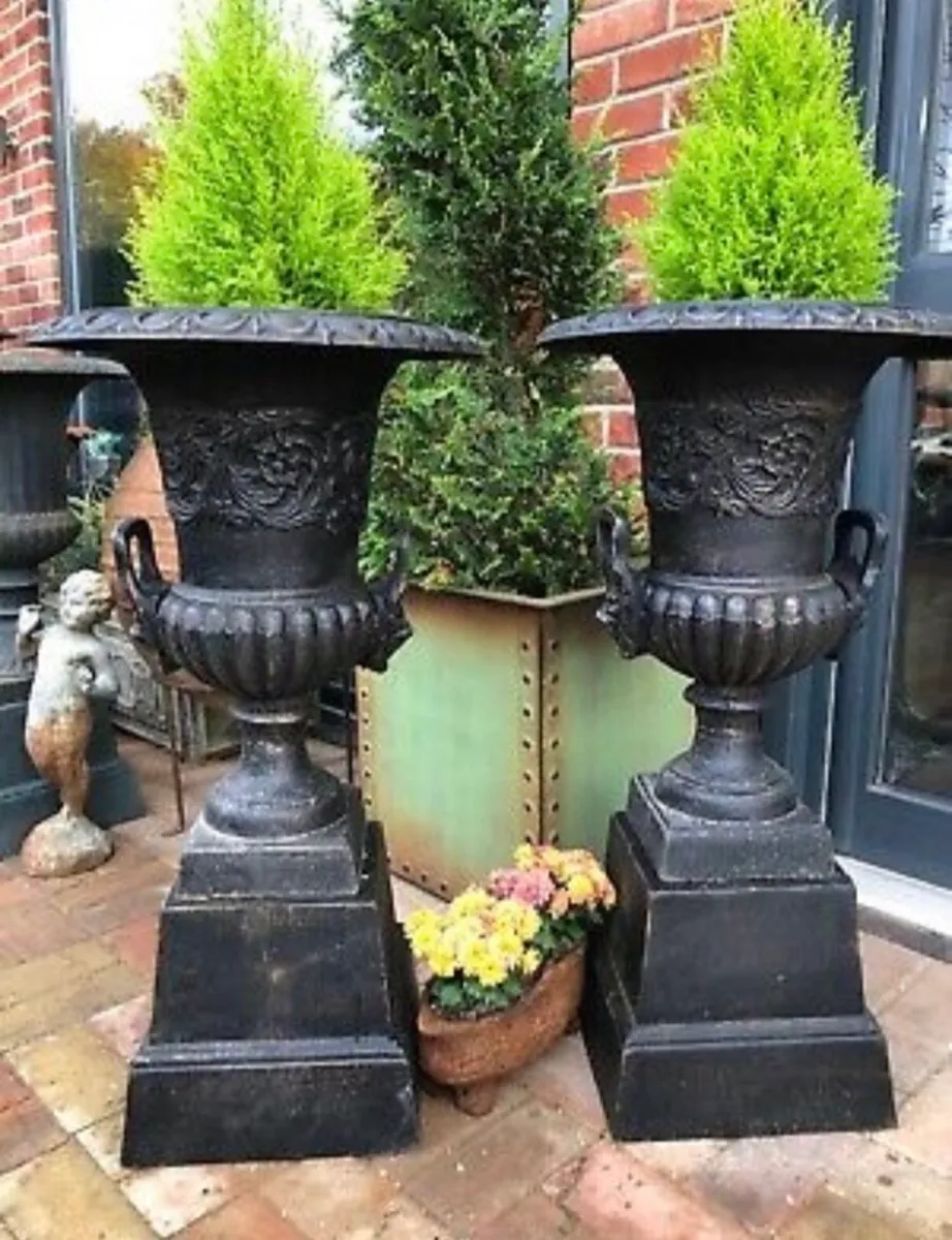 PAIR OF CAST IRON GARDEN URNS ON BASES