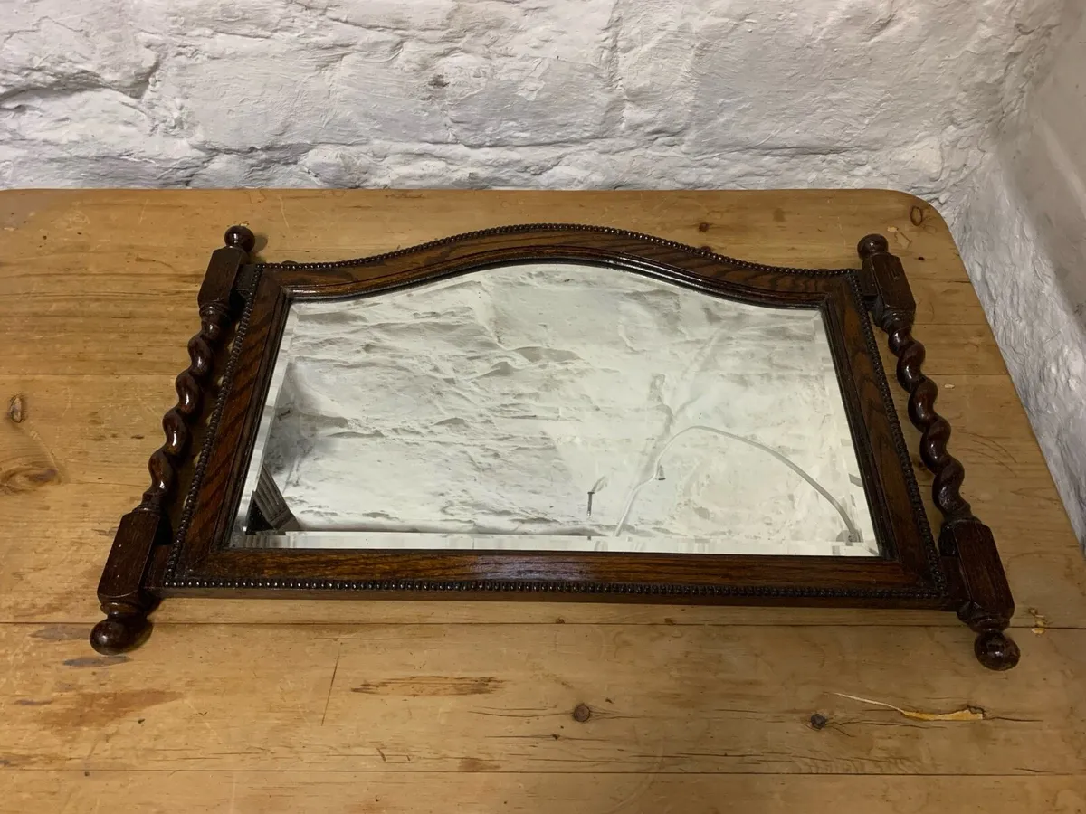 Antique oak bevelled edged mirror.