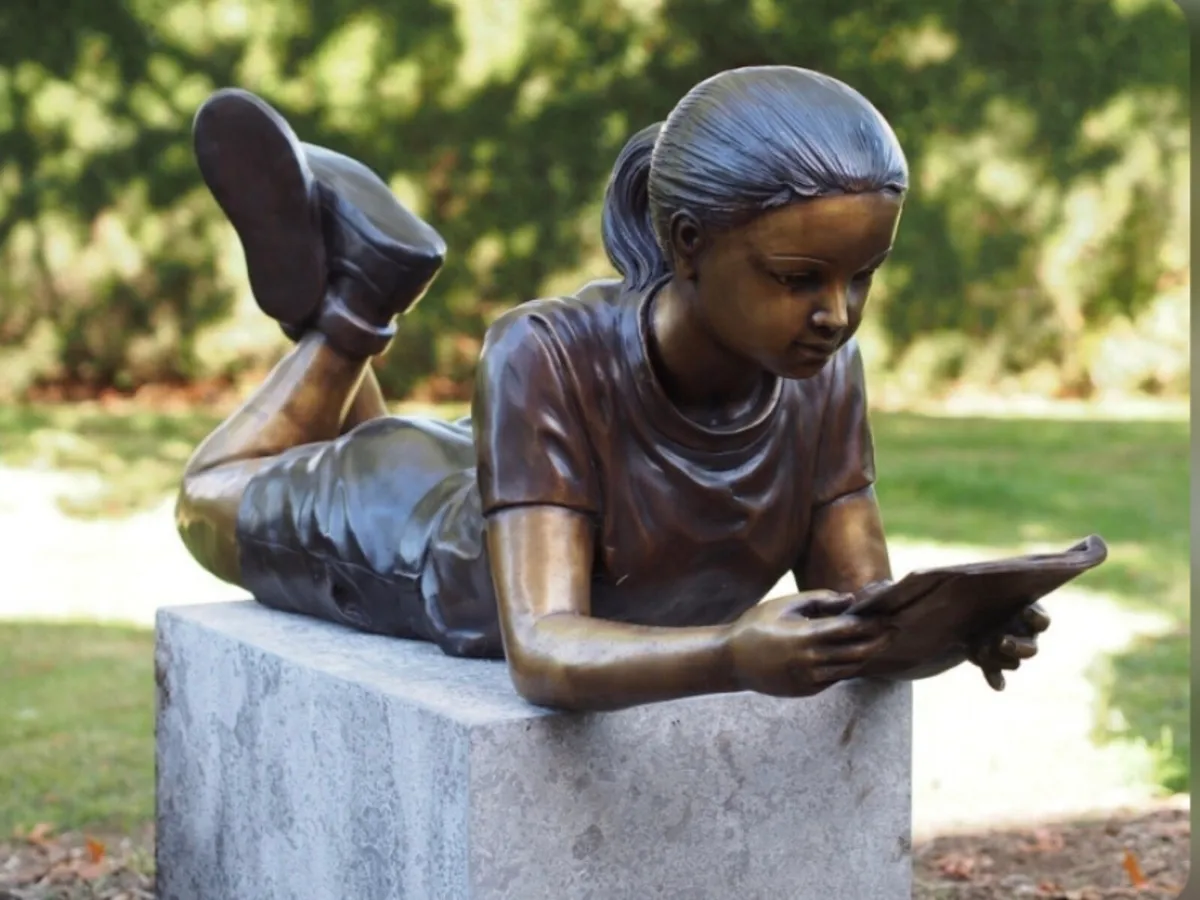 Bronze life size girl reading book