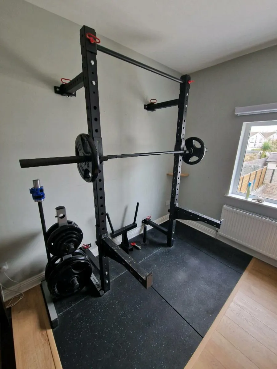 Home gym with wall-mounted rack, bars & weights - Image 1
