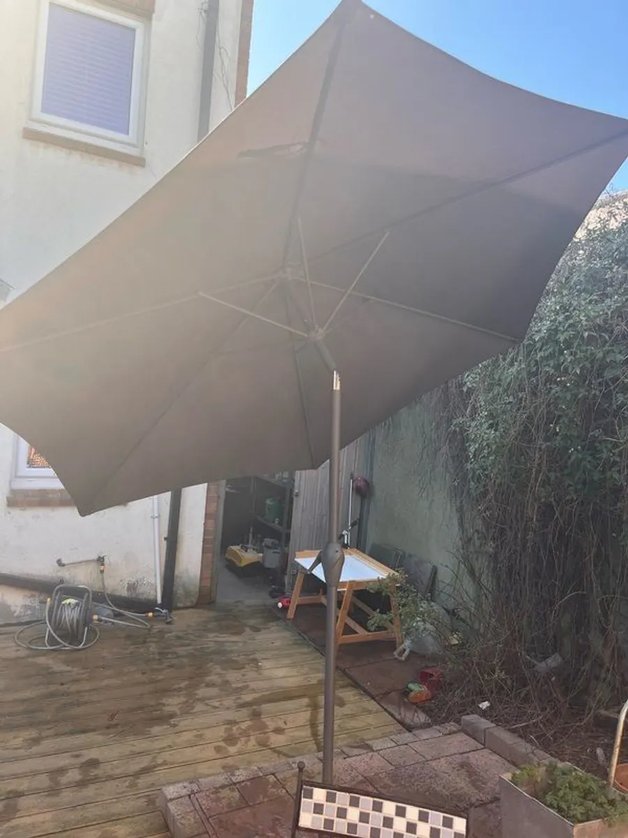 Quality parasol with base.Purchased at Arboretum. New and hardly used. - Image 1