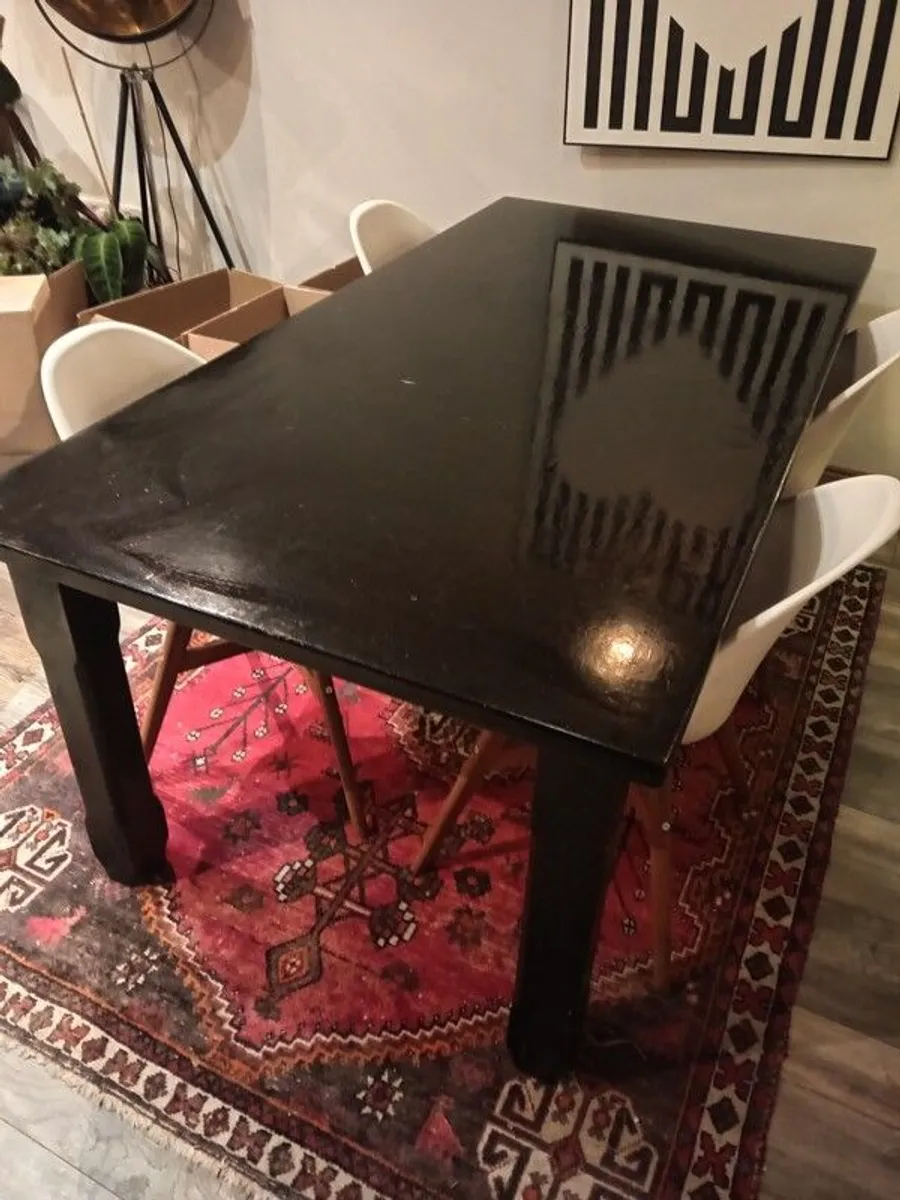 Heavy black painted wooden dinner table and four white chairs - Image 1