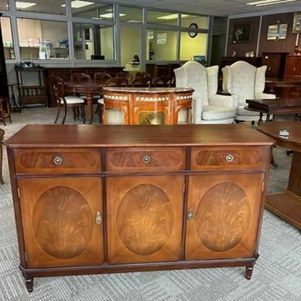 Mahogany flamed three drawer sideboard. Enclosed o