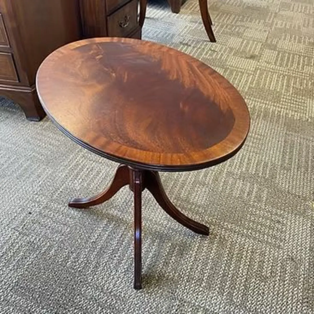 Fabulous mahogany flamed oval tilt top side table.