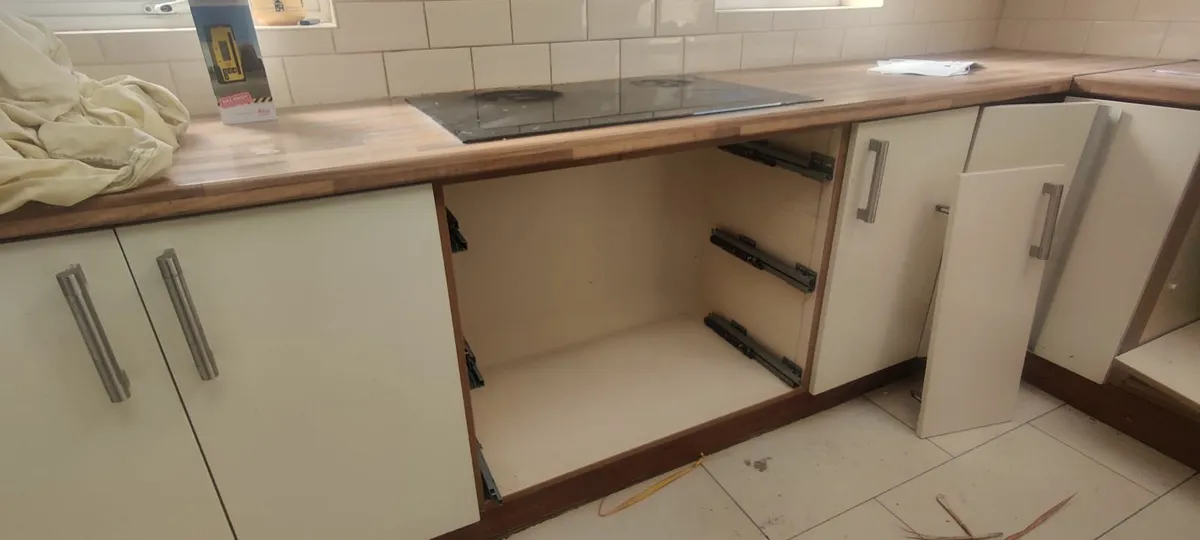 Kitchen cabinets with hob, fan, fridge freezer - Image 1