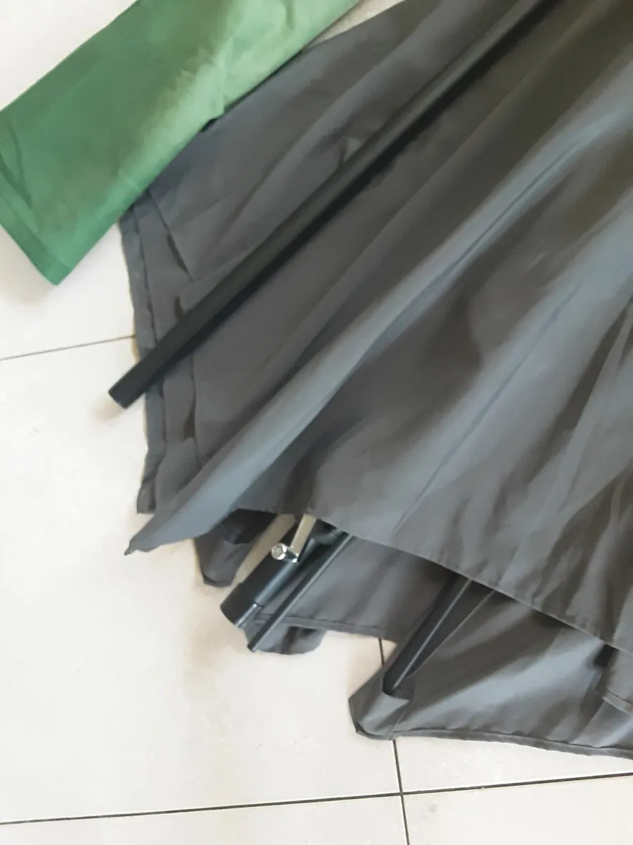 Large dark grey patio umbrella with protective cov - Image 1