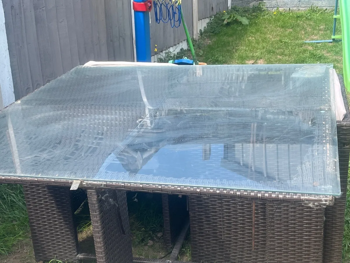 Damaged Rattan garden table and chairs - Image 1