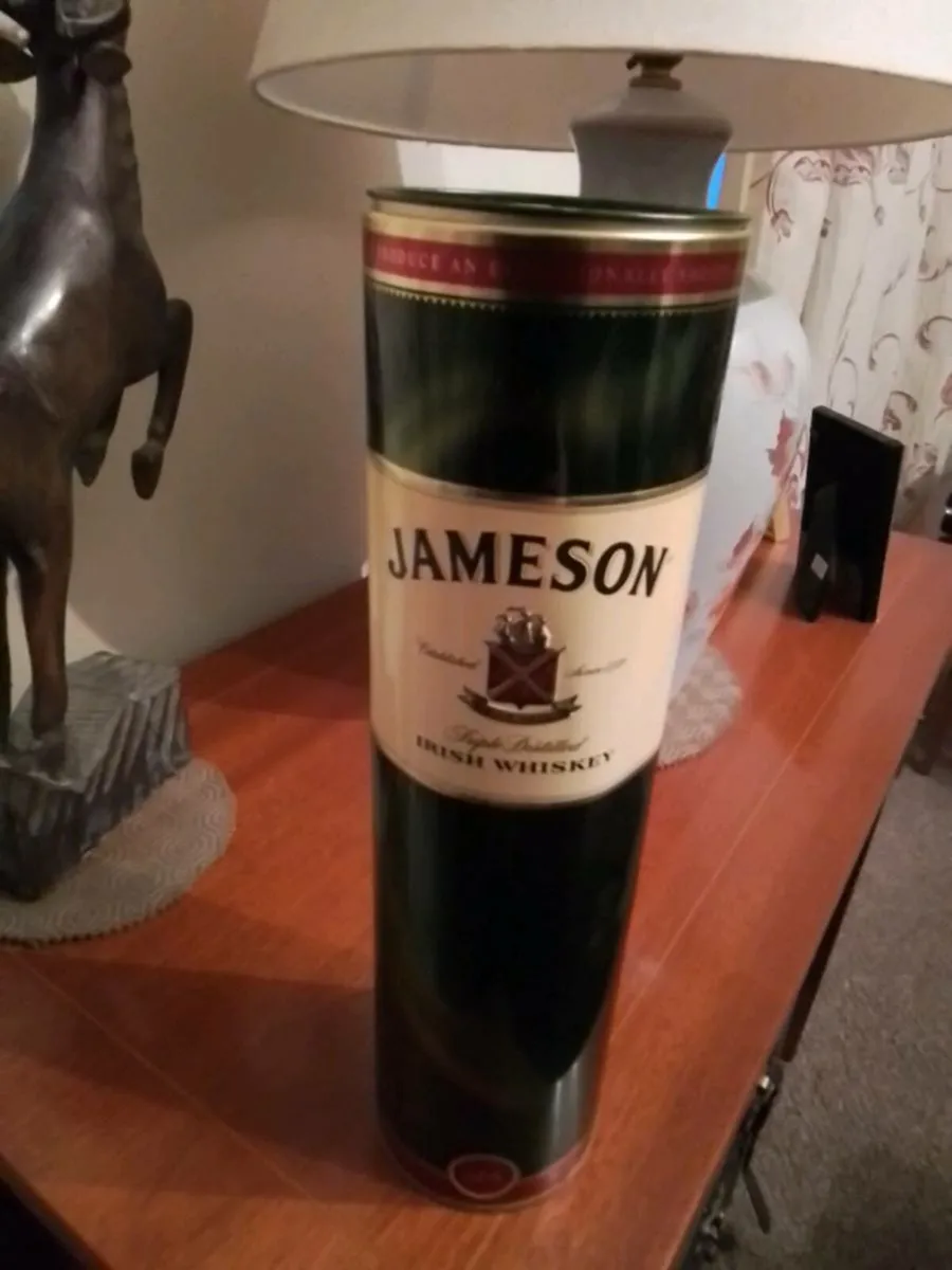 Two Jameson whiskey tin bottle containers