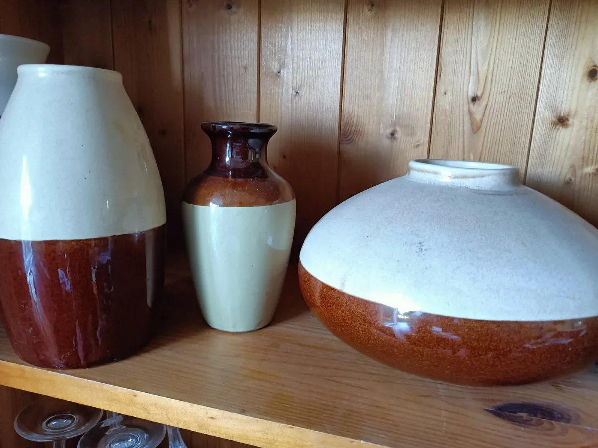 A set of 3 solid ceramic vases