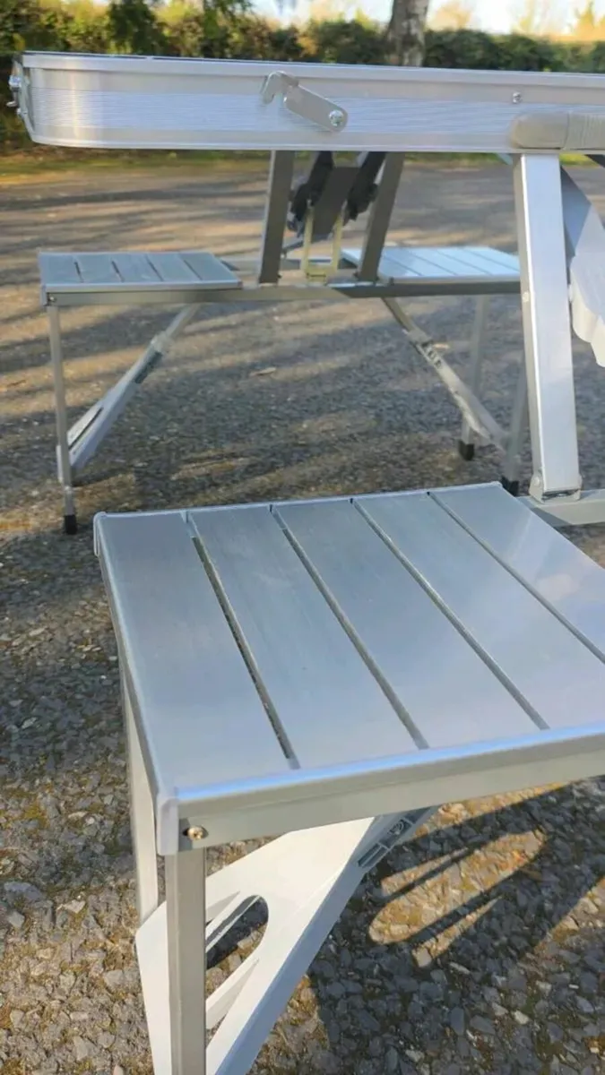 Foldable camping table with four seats. - Image 1