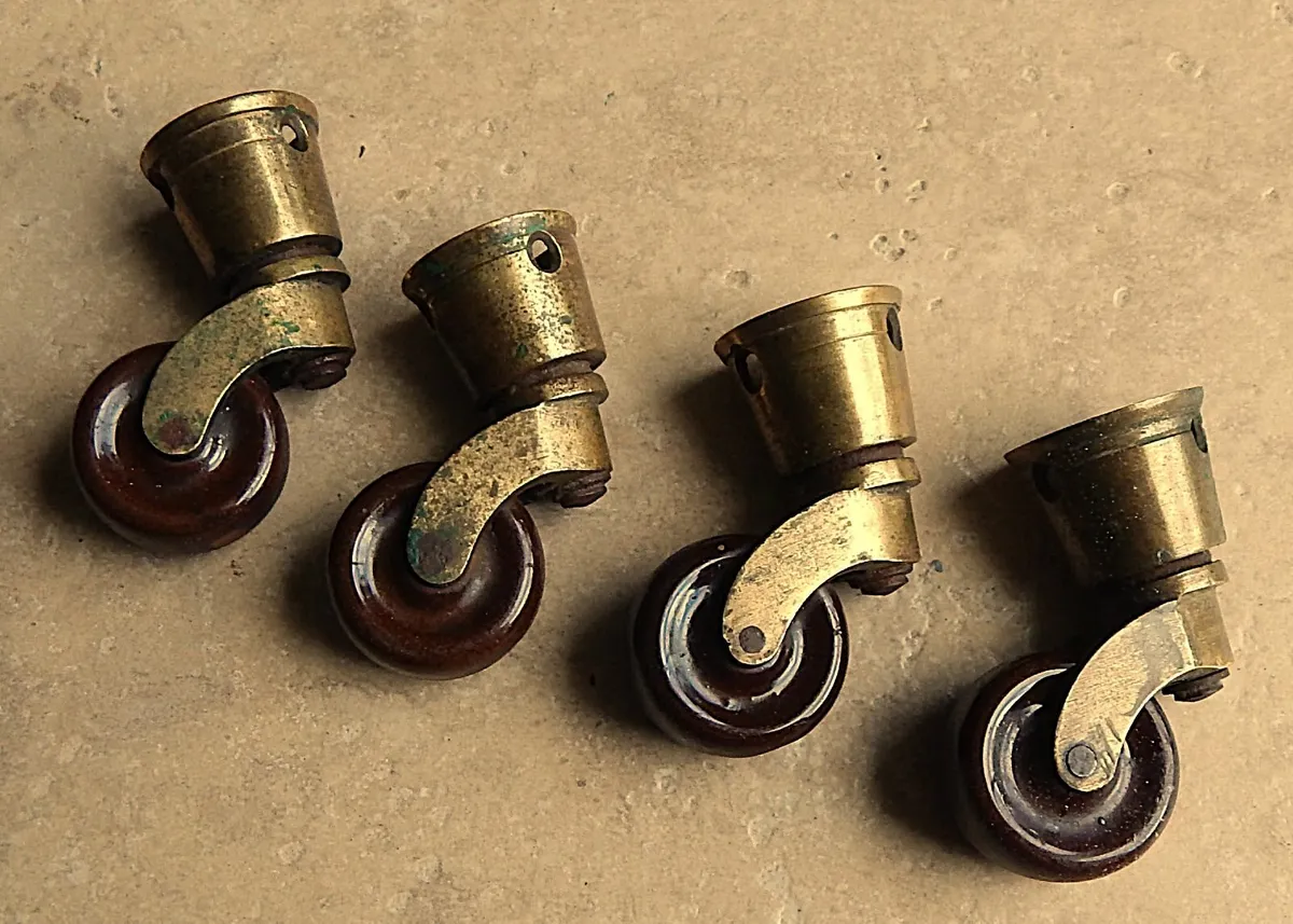 Set of 4 Antique Brass and Ceramic Round Castors - Image 1