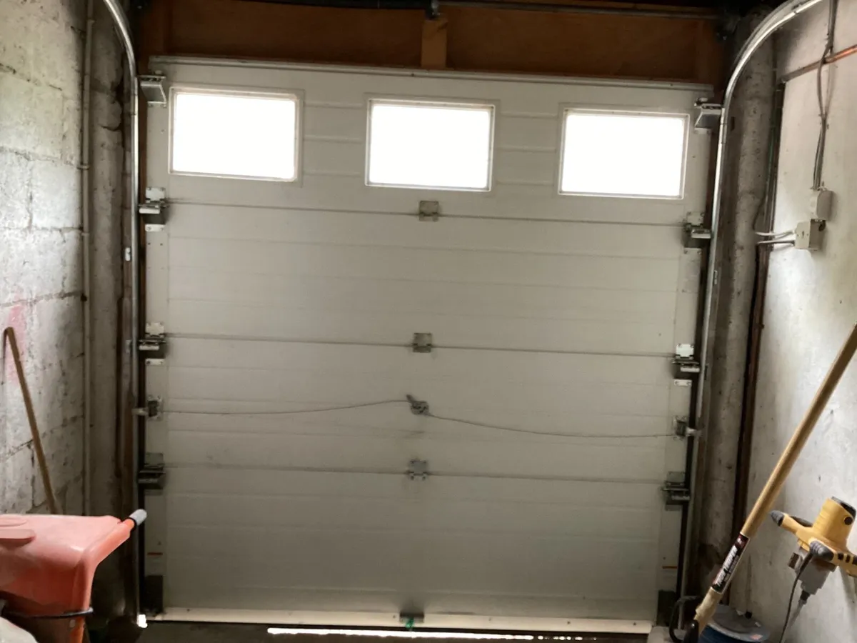 Garage door with frame mechanism - Image 2