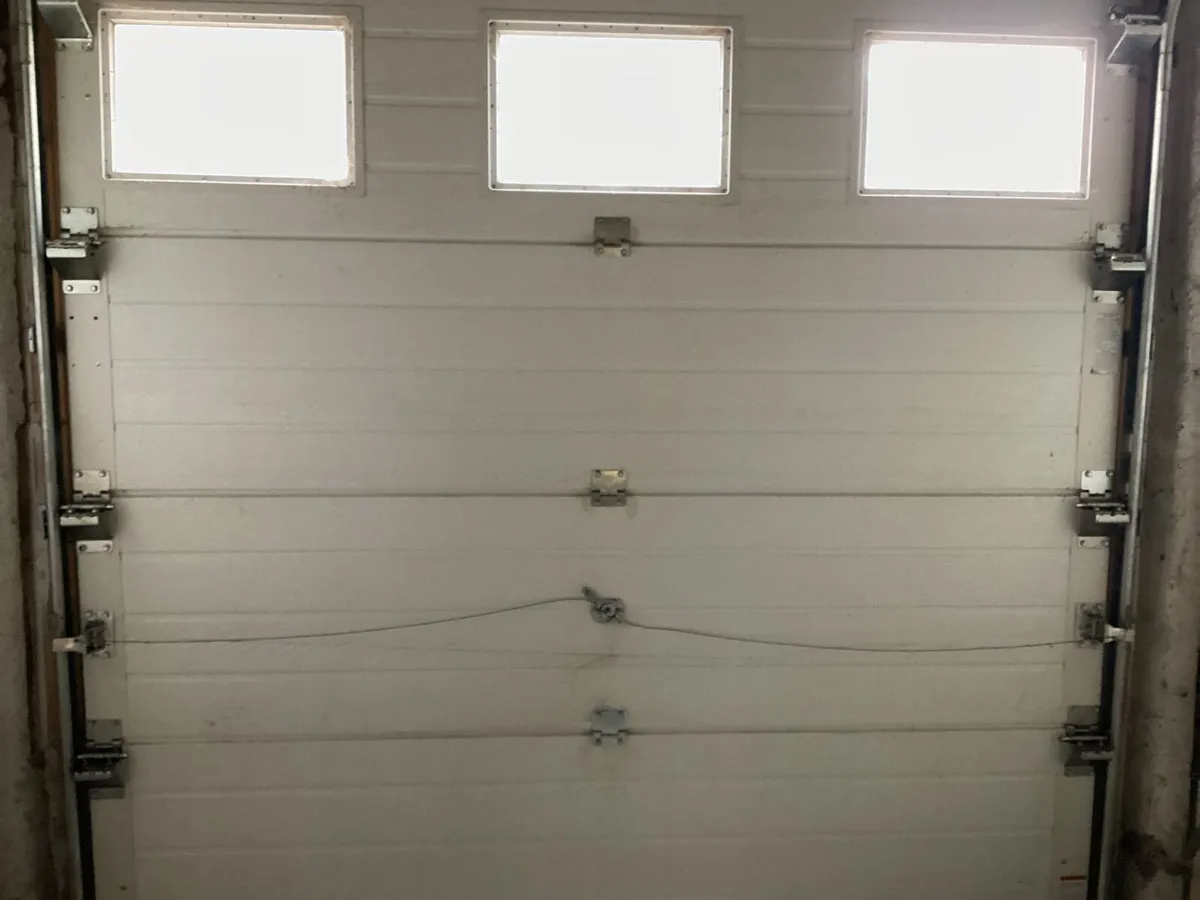 Garage door with frame mechanism - Image 3