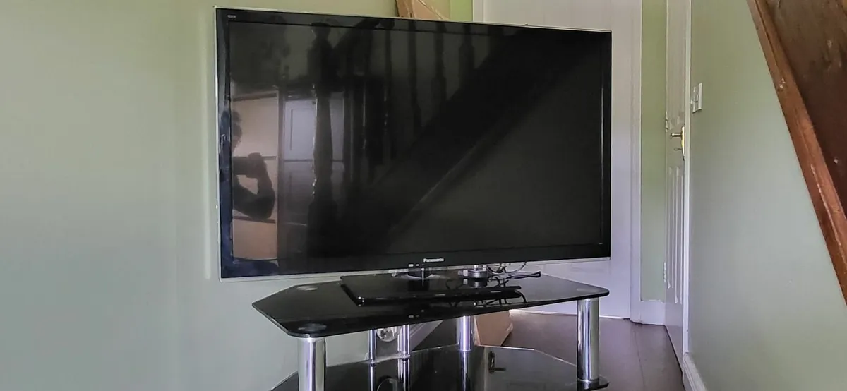Smart TV with its stand - Image 1
