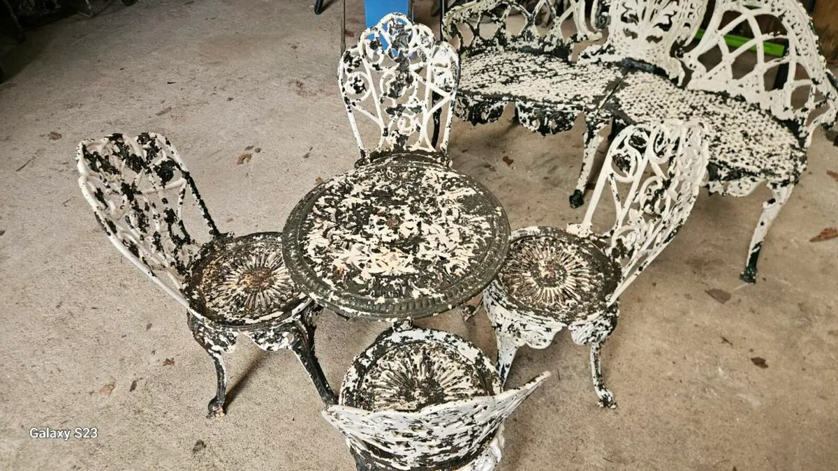 Cast iron table and four chairs - Image 1