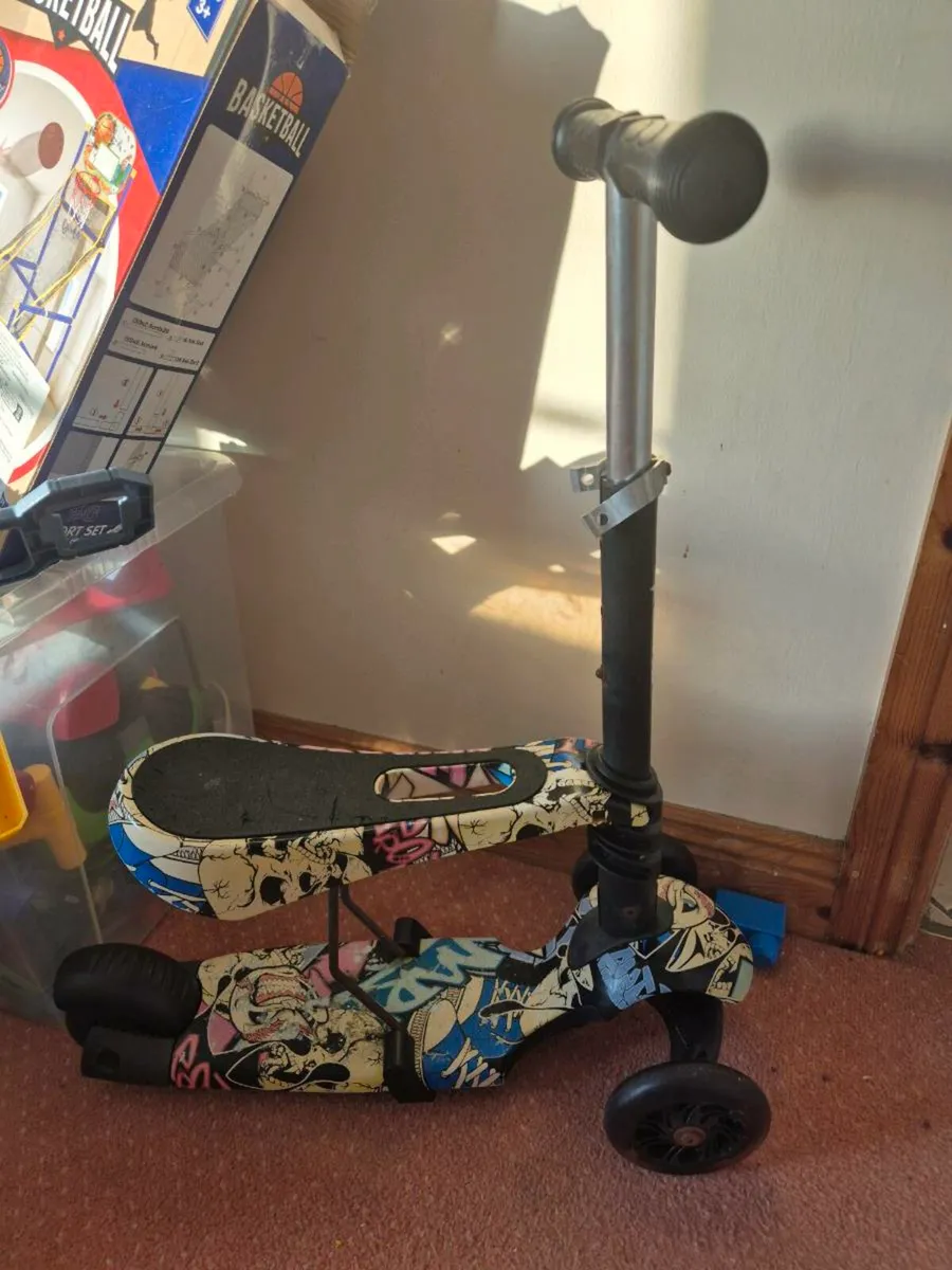 Kids sit on scooter
