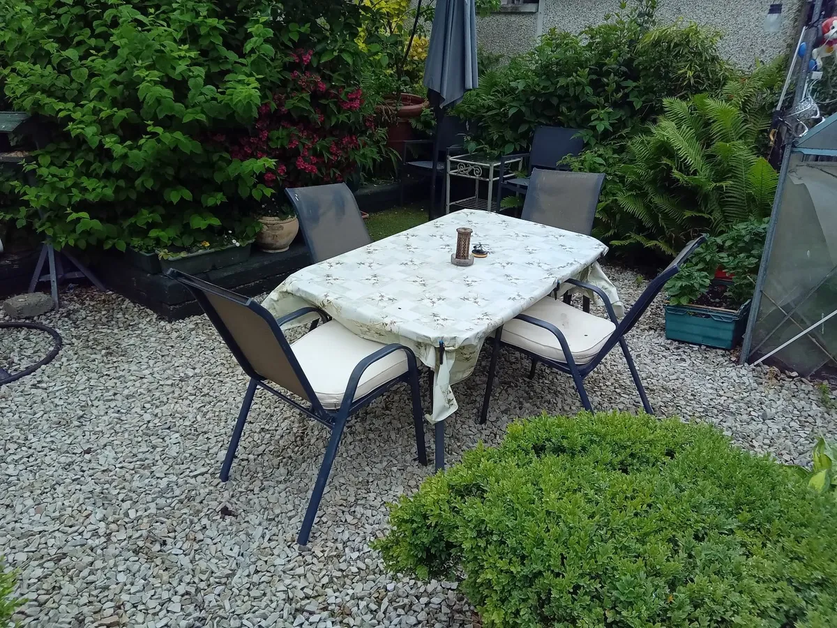 Outdoor dining table s d four chairs with cushions
