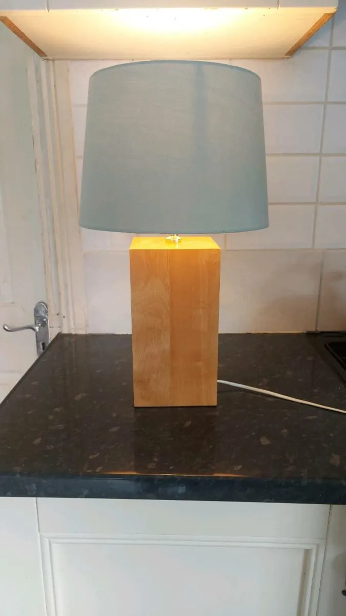 Wooden based table lamp with pale green shade